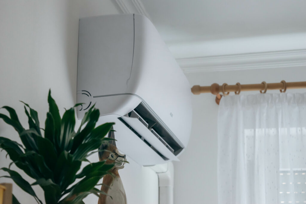 Ductless mini-split air conditioner on a white wall closeup.